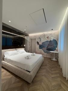 a bedroom with a large white bed and a desk at Saretta Luxury Suites in Cagliari +20 photos