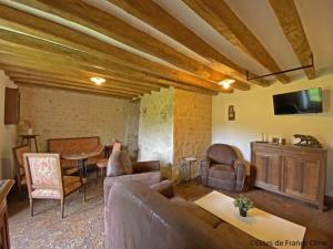 a living room with a couch and a table at Charmante longère avec jardin et wifi - FR-1-497-216 in Saint-Martin-des-Pézérits