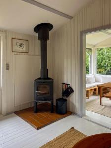 a living room with a stove in a room at Nature-Rich 60S Holiday Home By Isefjord in Jægerspris