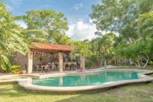 a swimming pool in a yard with a gazebo at Casa Cactus Buenavista in Bacalar