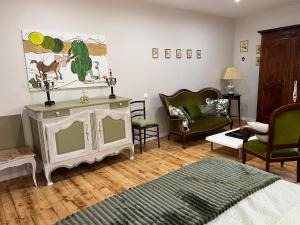 a living room with a bed and a couch at Gîte de charme à Souvigny avec jardin et animaux acceptés - FR-1-489-583 in Souvigny