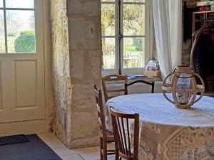 a dining room with a table with a lantern on it at Maison de charme avec cheminée au cœur du Parc Naturel du Perche - FR-1-497-235 in Loisail