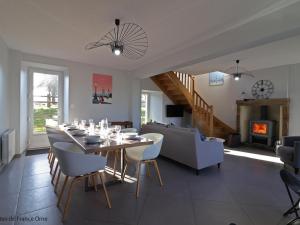 a dining room and living room with a table and chairs at Maison normande rénovée avec grand jardin, idéale pour famille, proche lac et randonnées - FR-1-497-143 in Ménil-Gondouin