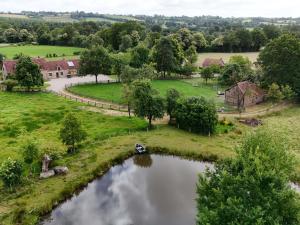 an aerial view of a river with a boat in it at Maison authentique avec jardin et terrasse en Normandie, animaux acceptés - FR-1-497-142 in Céaucé