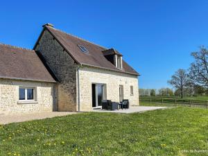 a stone house with two chairs on a lawn at Charmante maison en pierres restaurée, WIFI, 2 ch. - FR-1-497-241 in La Mesniere