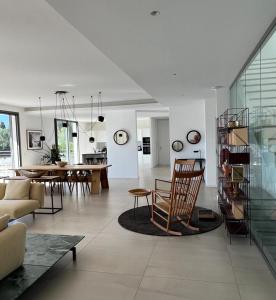 a living room with a couch and a table at Contemporary Villa with Sea View, Infinity Swimming pool, Gym , Cinema room,Lift in Nice