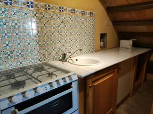 a kitchen with a sink and a counter top at Traditional Apartment In The Heart Of Umbria in Poggio Aquilone