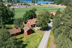 an overhead view of a house with trees and a road at Cozy Cottage By Töcksfors Lakes in Töcksfors
