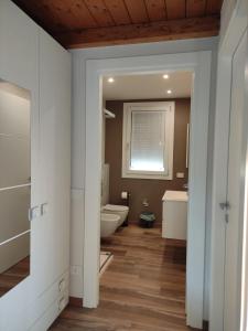 a bathroom with a toilet and a sink at Appartamenti Del Borgo in Borgosesia +62 photos