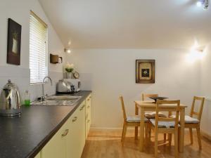 a kitchen with a table and a small table and chairs at High Moor Cottage in Dufton