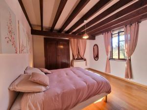 a bedroom with a large bed in a room at Gîte 12 Pers. Charme Piscine Intérieure Chauffée, Salle de Jeux - FR-1-496-346 in Saint-Priest-la-Prugne +28 photos