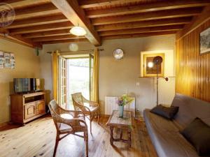 a living room with a couch and a table at Chalet familial à 5 min des pistes de ski de Chalmazel, 3 chambres, cheminée, animaux acceptés - FR-1-496-138 in Le Champas