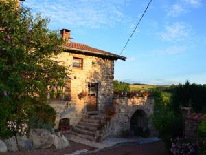 una casa in pietra con una scala che la porta di Gîte charmant avec four à pain, jardin, terrasse, jeux et poêle à bois, acceptant animaux - FR-1-496-137 a Chirassimont