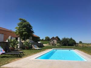 a swimming pool in the yard of a house at Gîte charmeur avec piscine, Wi-Fi & animaux admis - FR-1-496-143 in Saint-André-dʼApchon