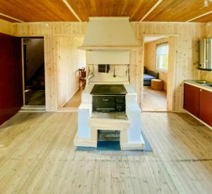 a kitchen with a stove in the middle of a room at Rural Magic In The Heart Of Nature in Krokströmmen
