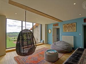 a room with a hammock hanging from the ceiling at Maison mitoyenne spacieuse avec jardin, terrasse et internet - FR-1-496-312 in Saint-Symphorien-de-Lay