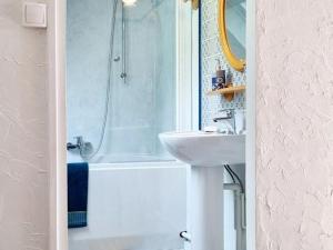 a white bathroom with a sink and a shower at Gîte charmant au bord de l'eau avec terrasse, cheminée et équipements complets à Lesquielles-St-Germain - FR-1-532-18 in Guise