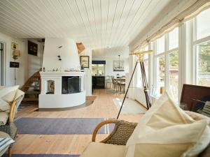 a living room with a fireplace and a couch at Beachfront Gem With Outdoor Kitchen In Hvaler in Skjærhollen