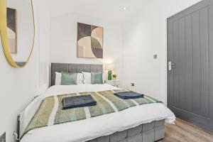 a bedroom with a large bed with a mirror at Central Luxe Flats With Spa Facilities in Cardiff