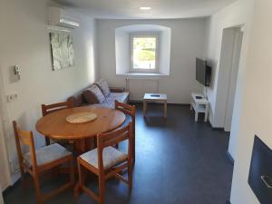 a living room with a table and a couch at Apartment old house Koren in Tržič