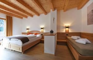 Postel nebo postele na pokoji v ubytování Hotel Brunello