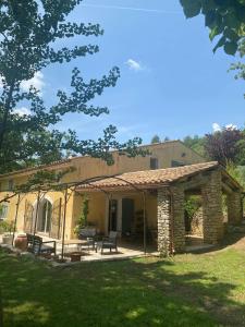 a building with a patio in a yard at Provencal Villa With Panoramic Views In Luberon in Apt
