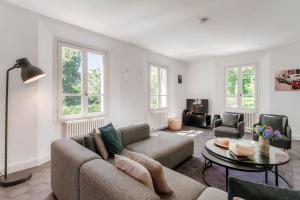a living room with a couch and a table at Villa Casasco - by MyHomeInComo in Casasco Intelvi