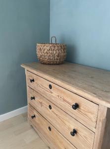 a wooden dresser with a basket on top of it at Seaside Cabin With Ocean View In Odsherred in Nyrup