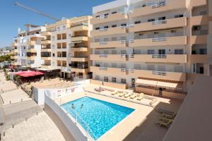 an aerial view of a building with a swimming pool at Espadarte - Sea view by HD in Quarteira