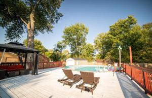 a deck with chairs and a swimming pool at Lush Hideaway with HotTub & Pool 6 mins kings Island in Mason