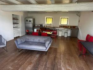 ドルチェアックアにあるStone Farmhouses Among Olives And Vinesのソファとキッチンのあるリビングルーム +2枚の写真
