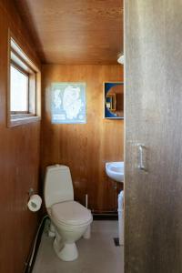 a bathroom with a toilet and a sink at Adorable Retro Home With Lovely Terrace in Bryrup +30 photos