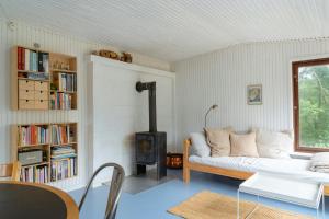 a living room with a couch and a wood stove at Adorable Retro Home With Lovely Terrace in Bryrup