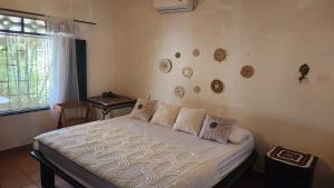 a bedroom with a bed in a room with a window at Finca Hotel Auraviva in Ciénaga de Oro