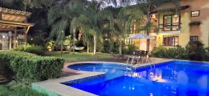 a swimming pool in front of a house at Villa do Cajueiro Imbassaí by LVF in Imbassai +38 photos