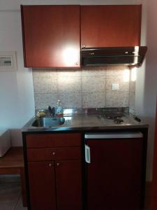 a kitchen with a sink and a stove at Hotel Kosmas in Sarti