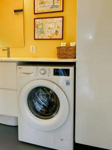 a washer and dryer in a laundry room at Family Cabin By The Sea With Private Pier in Ula