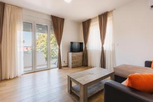 a living room with a couch and a coffee table at Chez Vous in Ulcinj