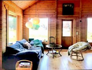 a room with a bed and a table in a cabin at Family-Friendly Log Cabin Near Tisvildeleje Beach in Vejby