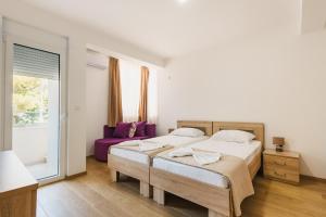 a bedroom with two beds and a window at Chez Vous in Ulcinj