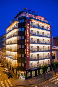 a tall building with a hotel sign on it at Petit Palau - Adults Only in Blanes