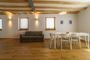 a living room with a table and chairs and a couch at Casa Corradini by Go New Location in Carano
