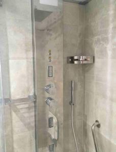 a shower with a glass door in a bathroom at Historic Villa In Sant Antonino With Sea Views in SantʼAntonino