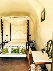 a bedroom with a canopy bed and a table at Historic Villa In Sant Antonino With Sea Views in SantʼAntonino
