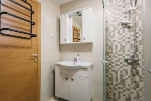 a bathroom with a sink and a shower with a mirror at Chez Vous in Ulcinj +61 photos