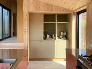 a kitchen with wooden ceilings and a counter top at Modern Summer House Overlooking The Water in Faaborg