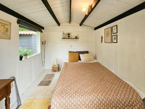 a bedroom with a bed in a small room at Holiday Home With Two Annexes Near The Sejerø Bay in Høve