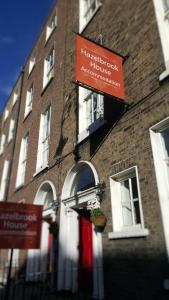 a building with a red sign on the side of it at Hazelbrook Lodge in Dublin