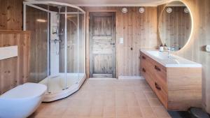 a bathroom with a shower and a toilet and a sink at Modern Family Cabin At Hovden Alpin in Hovden +12 photos