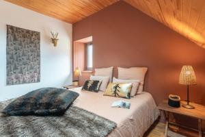 a bedroom with a large bed with pillows on it at Chez Louise in Cauterets
